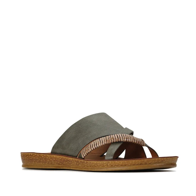 The Los Cabos Womens Bride Khaki Flat Slide Sandal features wide suede straps with a decorative woven bamboo-inspired accent and a brown textured flat sole, showcased in a side profile against a white background—an effortlessly chic choice for summer slides or elegant resort wear.