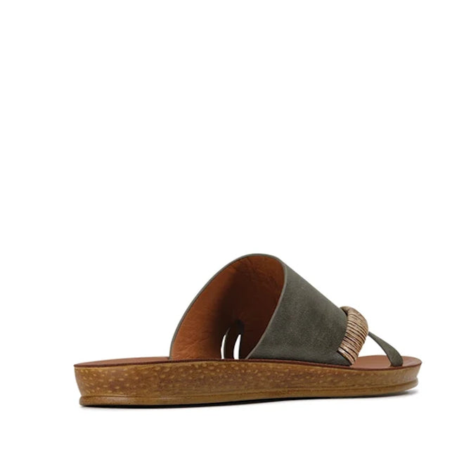 The Los Cabos Womens Bride Khaki Flat Slide Sandal features a wide olive green strap with decorative stitching and a brown, textured flat sole. Perfect as chic resort wear or stylish summer slides, this sandal is displayed at a slight angle against a white background.
