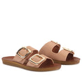 Introducing the Los Cabos Womens Dina Pecan Beige Light Flexible Two Strap Slide Sandal, featuring a pair of nude-colored slides with two wide straps adorned with large gold buckles and flat brown soles, thoughtfully designed with an anatomical footbed for enhanced comfort.