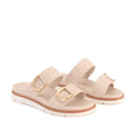 The Los Cabos San Women’s Slide Double Strap Sandal in Bone features two wide straps with gold buckle accents and white platform soles with brown trim. These minimalist slide sandals offer the perfect blend of comfort and style for summer, shown here against a white background.