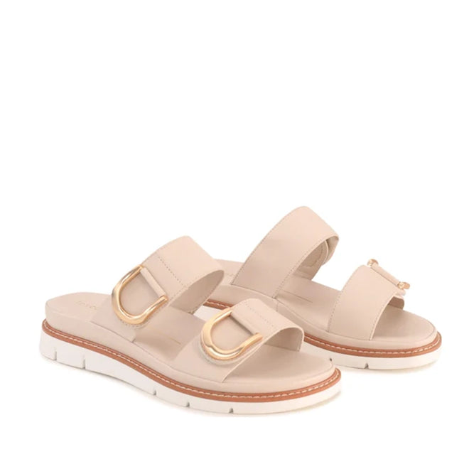 The Los Cabos San Women’s Slide Double Strap Sandal in Bone features two wide straps with gold buckle accents and white platform soles with brown trim. These minimalist slide sandals offer the perfect blend of comfort and style for summer, shown here against a white background.