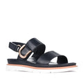 Introducing the Los Cabos Sana Black Sandal With Back Strap: featuring two wide black straps, a stylish gold buckle detail on the side, an adjustable slingback for a secure fit, and a thick white sole accented with brown trim—making it the perfect comfortable summer sandal for any occasion.