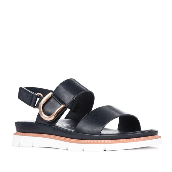 Introducing the Los Cabos Sana Black Sandal With Back Strap: featuring two wide black straps, a stylish gold buckle detail on the side, an adjustable slingback for a secure fit, and a thick white sole accented with brown trim—making it the perfect comfortable summer sandal for any occasion.