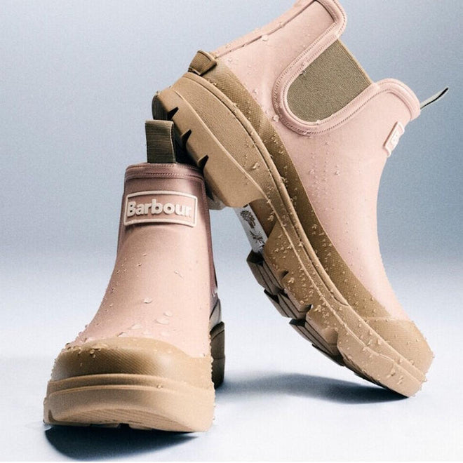 Two Barbour Nimbus Gardenia Pink/Bleached Olive Chelsea Wellingtons women's rainboots with chunky tan soles and elastic side panels, shown with water droplets on the surface against a light gradient background., 5063669171745, 5063669171752, 5063669171769, 5063669171776, 5063669171783, 5063669171790