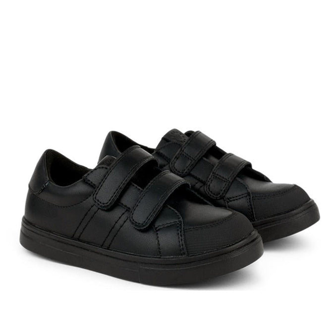 The Pretty Brave Atlas Trainer Black Leather School Shoe features double Velcro straps, a low top design, and rubber soles—ideal leather trainers for kids' school needs. Pictured: pair side by side on a white background.