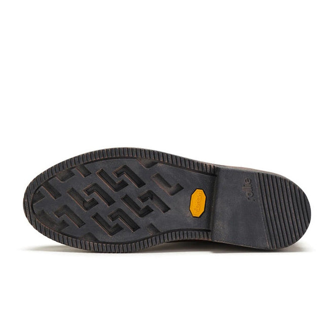 The image shows the black Vibram outsole of the Rollie Womens Chelsea Rise Vintage Mocha Leather Boot, featuring a patterned tread, yellow Vibram logo, and horizontal grooves at the heel., 9339554341682, 9339554341699, 9339554341705, 9339554341712, 9339554341729