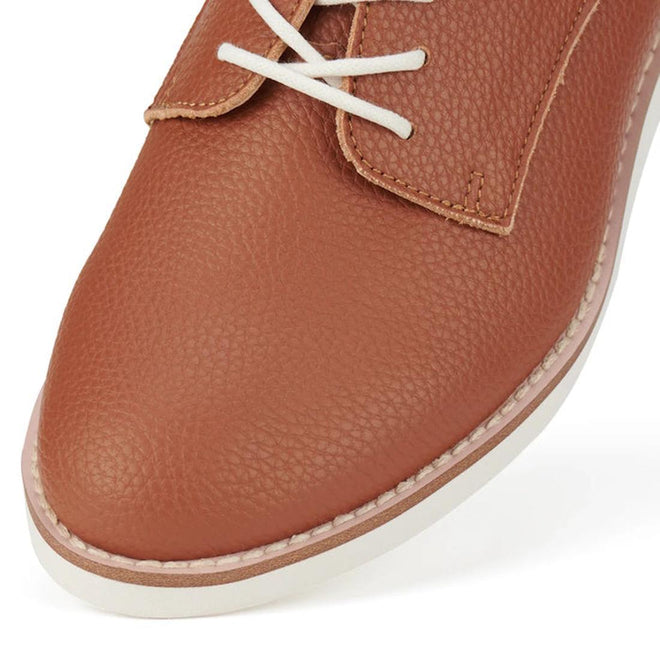 Close up view of Brown Cognac Rollie Derby showing pebbled look to the Brown recycled leather shoe with white laces on a white background.,
9781760789831,
9781760789848,
9781760789855,
9781760789862,
9781760789879,
9781760789886,, 9781760789831, 9781760789848, 9781760789855, 9781760789862, 9781760789879, 9781760789886