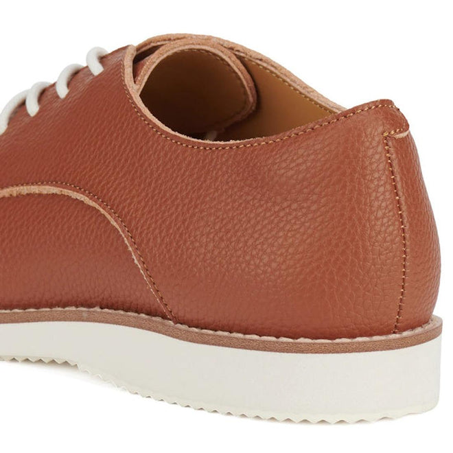 Heel shot of Rollie Derby Cognac Brown recycled leather shoe with pebbled textured look in the leather, white laces on a white background.,
9781760789831,
9781760789848,
9781760789855,
9781760789862,
9781760789879,
9781760789886,, 9781760789831, 9781760789848, 9781760789855, 9781760789862, 9781760789879, 9781760789886