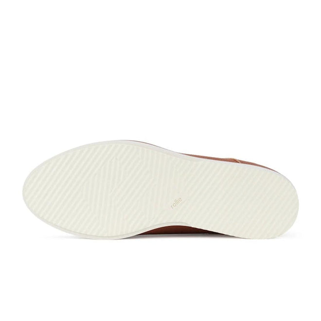 Close-up of a shoe sole of the Rollie Derby Cognac shoe with a textured pattern on a white background.,
9781760789831,
9781760789848,
9781760789855,
9781760789862,
9781760789879,
9781760789886,, 9781760789831, 9781760789848, 9781760789855, 9781760789862, 9781760789879, 9781760789886