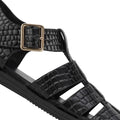 Close-up of a Rollie Womens Fisherman Sandal Black Embossed Leather, featuring a black textured finish, gold-tone buckle, and a cushy padded footbed., 9339554003016, 9339554003023, 9339554003030, 9339554003047, 9339554003054, 9339554003061