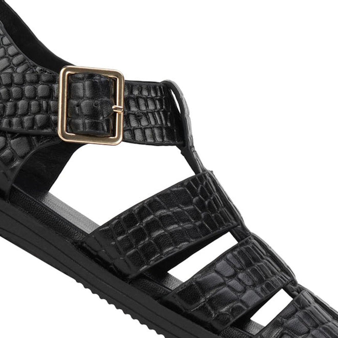 Close-up of a Rollie Womens Fisherman Sandal Black Embossed Leather, featuring a black textured finish, gold-tone buckle, and a cushy padded footbed., 9339554003016, 9339554003023, 9339554003030, 9339554003047, 9339554003054, 9339554003061