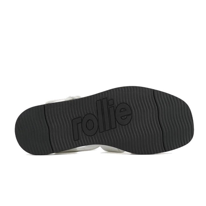 Black textured sole of the Rollie Womens Fisherman Sandal White Black Leather with a wavy pattern and a cushy padded footbed, featuring the brand name embossed in the center., 9339554003092, 9339554003108, 9339554003115, 9339554003122, 9339554003139, 54669
