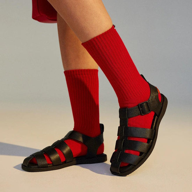 Style option on Rollie Fisherman Black sandals worn on a model with red socks on a neutral background showing both feet in a walking pose.,
9781760777722,
9781760777739,
9781760777746,
9781760777753,
9781760777760,
9781760777777,