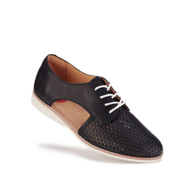 The Rollie Womens Sidecut Punch Black Leather Shoe features black and brown leather, white laces, perforated toe and sides, cushy EVA midsoles, and a white sole, shown against a white background.