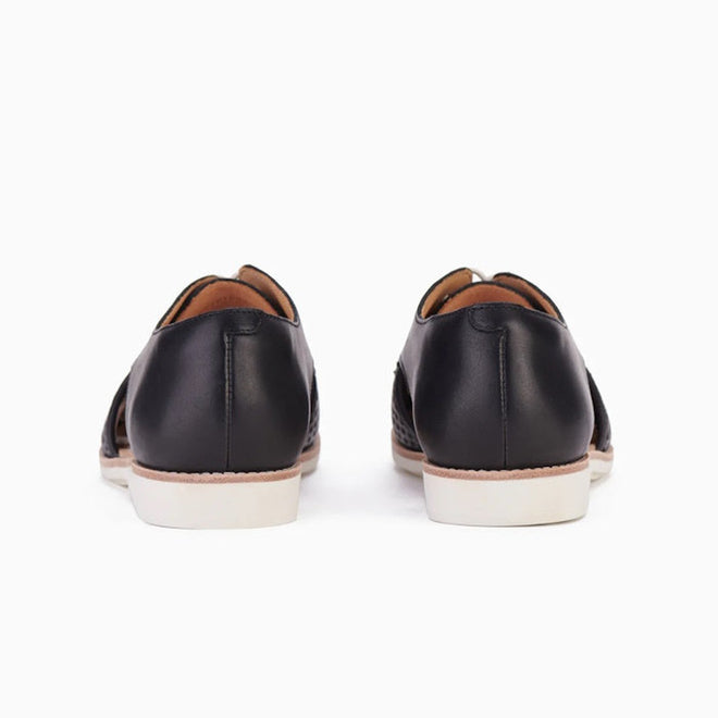 The Rollie Womens Sidecut Punch Black Leather Shoe features cushy EVA midsoles and white soles, shown from the back on a plain white background., 9339554249179, 9339554249186, 9339554249193, 9339554249209, 9339554249216, 9339554249223, 9339554249230