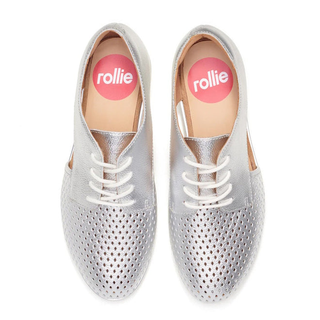 The Rollie Womens Sidecut Punch Silver Metallic Leather Shoe features metallic silver leather, white laces, perforated toe design, tan insoles with "rollie" in a pink circle, and an anti-slip rubber outsole for comfort., 9339554231341, 9339554231358, 9339554231365, 9339554231372, 9339554231389