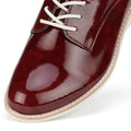 Close-up of toe of the left foot of a Rollie Derby Super soft Wine Crinkle Patent glossy burgundy shoe with white laces on a white background.,
9781760788742,
9781760788759,
9781760788766,
9781760788773,
9781760788780,
9781760788797,
9781760788803,