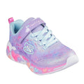 The Skechers Girls S Lights Eternal Heart Lights Trainer is a pastel purple and blue sneaker with glitter mesh, light blue laces, pink pull tab, Velcro strap, a sole of colorful hearts, and bright light-up features.