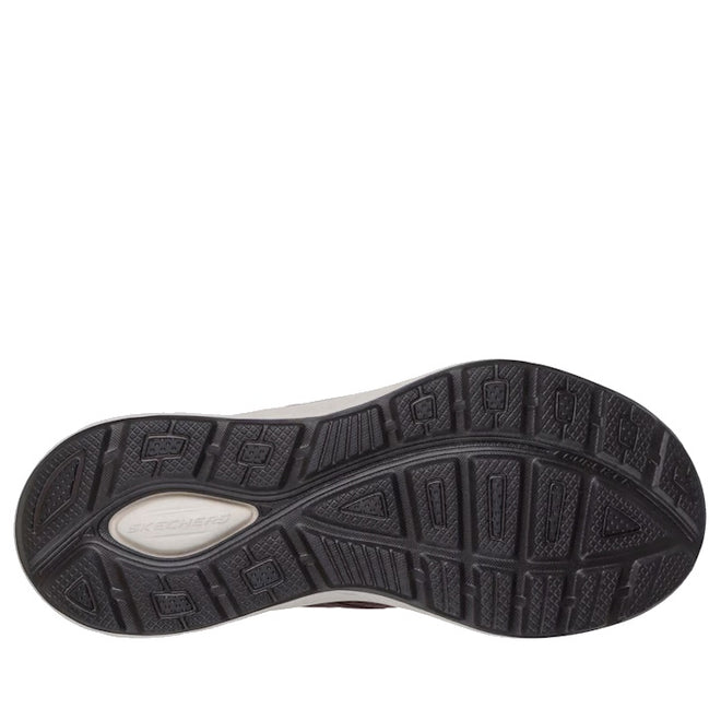 The image displays the black rubber outsole of the Skechers Mens Slip Ins Relaxed Fit Equalizer 6.0 Stoaver Brown, with a textured tread and an embossed Skechers logo near the heel.