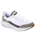 The Skechers Men's Slip-In Contour Foam Cozy Fit in white and taupe features gray/beige accents, quilting detail, a thick cushioned sole with Air-Cooled Memory Foam, beige heel/toe overlays, and a Skechers logo patch on the tongue.