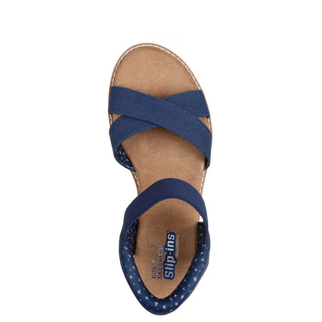 A top view of the navy Skechers Womens Bobs Desert Kiss Golden Lily SLIP IN sandal, featuring crisscross fabric straps and a cushioned tan insole. The heel area displays a dotted pattern for enhanced Memory Foam comfort., 49030, 198739558746, 198739558760, 198739558784, 49034, 49035