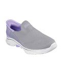 The Skechers Womens Slip Ins Go Walk 7 Mia in Grey Lavender features a breathable mesh upper, white sole, and light purple accents. Enjoy all-day comfort with its Air-Cooled Memory Foam insole and convenient hands-free design.