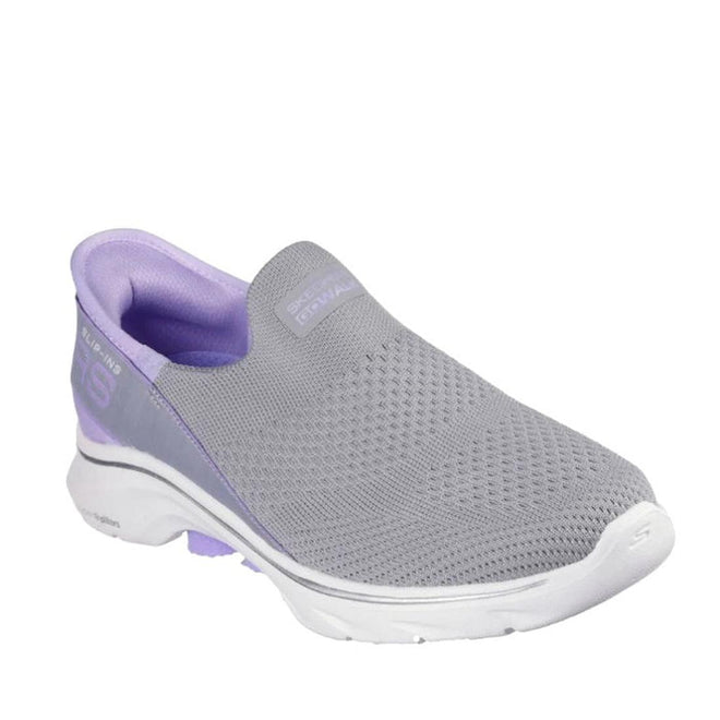 The Skechers Womens Slip Ins Go Walk 7 Mia in Grey Lavender features a breathable mesh upper, white sole, and light purple accents. Enjoy all-day comfort with its Air-Cooled Memory Foam insole and convenient hands-free design.