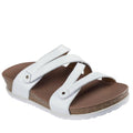 The Skechers Womens Arch Fit Granola Slim White Slide sandal features three white straps, a supportive brown footbed, and a cork midsole. Displayed on a white background.