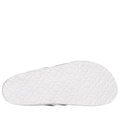 The image shows the bottom of a white Skechers Womens Arch Fit Granola Slim Slide, featuring a textured sole with raised clover-like shapes for comfort and support., 49043, 198739182224, 198739182231, 198739182248, 198739182255, 49048, 49049