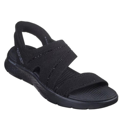 The Skechers Womens Slip Ins Sandals Go Walk Flex Belle Black features a black open-toe vegan design, two wide crisscross fabric straps, textured sole, and offers comfort and style for casual wear.