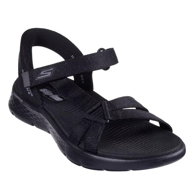 Black Skechers slip in Illuminate sandal with rigid heel but padded heel strap that allows the foot to slip in. Velcro adjustable strap over the top of the foot, thin strap on the outer foot that attachs to the double straps over the toe  white sole on a white background.,