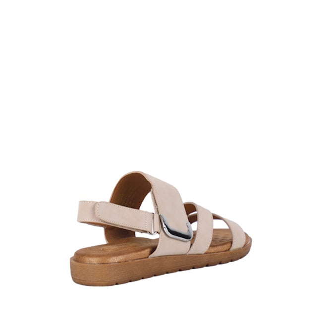 Introducing the Soultbush Flinders Beige Women’s Sandal with Back Strap, featuring a low, flat brown sole and wide straps accented by a metallic buckle detail on the side. Designed for comfort and convenience, it includes an adjustable Velcro strap for a personalized fit. The sandal is showcased from the back left angle against a white background.