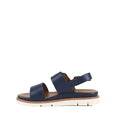 Introducing the Soultbush Garie Navy Blue Women’s Sandal with Back Strap: featuring two wide navy straps, a secure ankle strap with a buckle, a tan cushioned footbed, and a thick white sole with subtle grooves—perfect sandals for effortless coastal living.