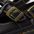 Close-up of Dr Martens Dunnet Flower Sandal Black Quad Platform with black full-grain leather straps, engraved brass buckles, detailed white stitching, and a 90s-inspired design., 190665809190, 190665809206, 190665809213, 190665809237, 190665809244, 52092