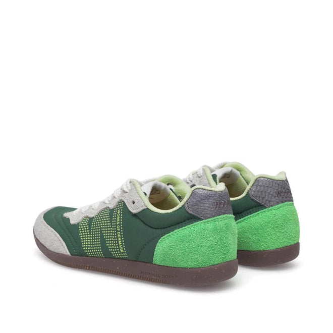 The Woden Nanna Apple Green Multi Lace Up Sneaker features green suede heels, dark green panels, gray accents, white laces, and yellow dotted side detailing, shown from a rear side angle on a white background., 50250, 5713326697834, 5713326697841, 5713326697858, 50253