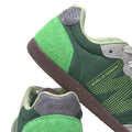 Close-up of Woden Nanna Apple Green Multi Lace Up Sneakers, featuring green tones with gray and light green accents, textured materials, WORKS OF DENMARK text on the side, WODEN on the heel, and a brown NATURAL SOFT sole., 50250, 5713326697834, 5713326697841, 5713326697858, 50253