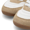 Close-up of Woden Nanna Blanc De Blance White Lace Up Sneakers with tan suede accents, white panels, white laces, and brown rubber soles embossed with "WODEN"—a lightweight, travel-friendly sneaker option., 50285, 5713326712193, 5713326712209, 5713326712216, 50289