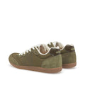 The Woden Nanna Dark Olive Lace Up Sneaker features olive green suede, white laces, gum soles, a gold "WOOLFS" heel tab, and WODEN Natural Soft Technology for lightweight, travel-friendly comfort., 5713326697506, 5713326697513, 5713326697520, 5713326697537, 5713326697544, 5713326697551