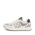 The Woden Rigmor Animal Damlation Lace Up Sneaker features white laces, beige and light gray panels, black polka dot accents, a black and white sole, a textured N logo, and high-quality LWG certified leather.