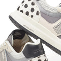 Close-up of Woden Rigmor Animal Damlation Lace Up Sneakers in grey, cream, and white, featuring black and white cow-print details. Made with LWG certified leather and a WODEN Natural Soft midsole for added comfort., 5713326695267, 5713326695274, 5713326695281, 5713326695298, 5713326695304, 5713326695311
