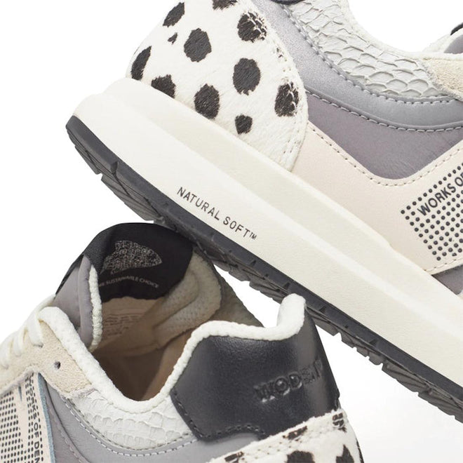 Close-up of Woden Rigmor Animal Damlation Lace Up Sneakers in grey, cream, and white, featuring black and white cow-print details. Made with LWG certified leather and a WODEN Natural Soft midsole for added comfort., 5713326695267, 5713326695274, 5713326695281, 5713326695298, 5713326695304, 5713326695311