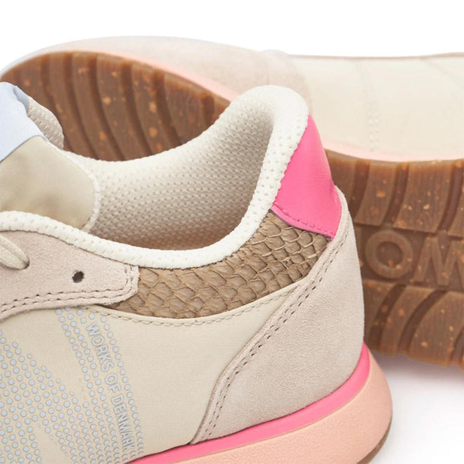 Close-up of the Woden Ronja Ivory Blush Lace Up Sneaker featuring beige leather, a textured brown heel, pink back accent, light blue side panel, cork insole, and a gum sole with tread pattern and partial "WORKS" embossing., 50265, 5713326700633, 5713326700640, 5713326700657, 5713326700664, 5713326700671