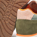 Close-up of the Woden Ronja Icon Light Algae Multi Lace Up Sneaker, featuring certified green suede, a textured pale pink heel, orange inner lining, and Woden branding embossed on the rubber sole and stitched on the heel., 50275, 5713326699838, 5713326699845, 5713326699852, 50279