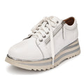 The Alfie & Evie Hosting Womens Leather Shoe in White/Silver is a lightweight platform sneaker with white laces, silver zipper detail, and a thick sole featuring cream and silver stripes—ideal for everyday comfort and style.