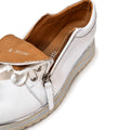 The Alfie & Evie Hosting Women's Leather Shoe in White/Silver features a platform sole, tan interior, side zipper, and top laces. Shown from an angled overhead view against a white background, this shoe blends style and comfort., 43583, 43584, 43585, 43586, 43587, 43588, 43589