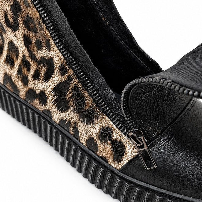 Close-up of the Alfie & Evie Womens Dynasty Black Leopard Cracked Leather Ankle Boot, featuring a textured platform sole, metallic leopard print side panel, and a partially unzipped black zipper showing its black inner lining., 50848, 50849, 50850, 50851, 50852, 50853, 50854