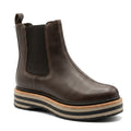 The Alfie & Evie Molten Choc Brown Leather Ankle Boot for women features a classic Chelsea design with a black elastic side panel and a chunky sole detailed in tan, black, and beige stripes.