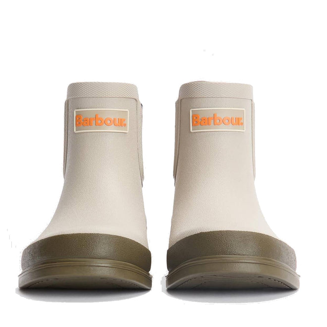 A pair of Barbour Abbeyfield Packable Ankle Wellingtons Mist, shown from the front against a white background. These lightweight beige ankle boots feature olive green soles and orange-and-white Barbour logo patches., 51823, 51824, 5063669171196, 5063669171202, 5063669171219, 51828, 51829