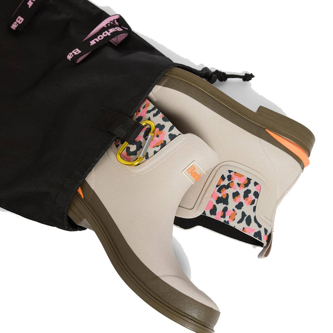 A pair of Barbour Abbeyfield Packable Ankle Wellingtons Mist, beige with olive soles and vibrant leopard print lining, shown partially out of a black drawstring bag with pink Bax branding. Lightweight and ideal for travel or outdoor adventures., 51823, 51824, 5063669171196, 5063669171202, 5063669171219, 51828, 51829