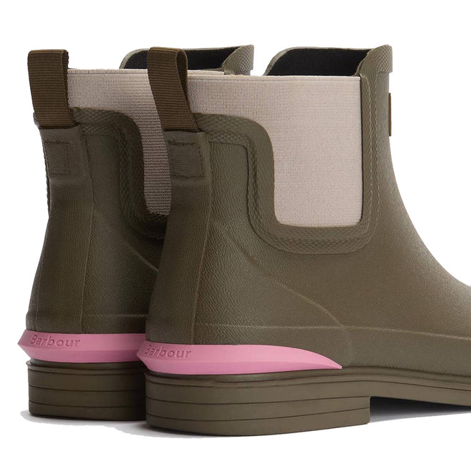 Close-up of Barbour Abbeyfield Packable Ankle Wellingtons Olive—olive green ankle boots with beige elastic panels, brown pull tabs, pink heel accents, and Barbour logo on the heel strip; lightweight wellies ideal as festival boots., 51830, 51831, 5063669171264, 5063669171271, 5063669171288, 51835, 51836